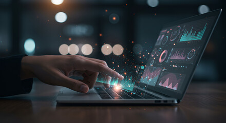 Person Using Laptop with Data Visualization Displayed on Screen and Bokeh Lights in the Background