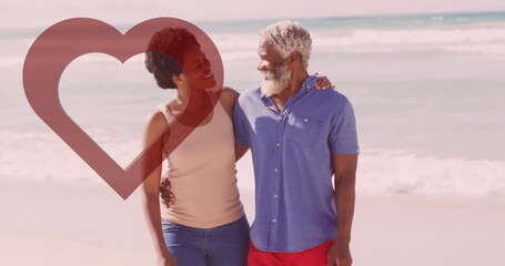 Walking on beach, elderly couple holding hands with heart animation overlay - Powered by Adobe