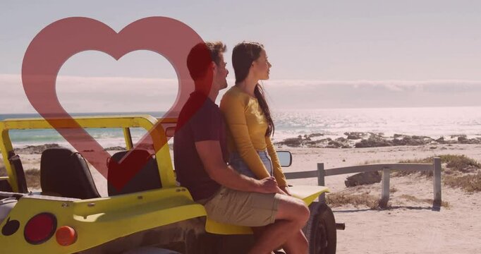 Couple sitting on yellow beach buggy by ocean with heart animation overlay