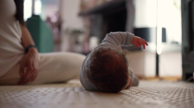 Baby rolling over on mat indoors, developing motor skills, early physical growth, learning body coordination, milestone in infant movement, peaceful home setting