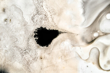 Abstract fluid dynamics of ink merging into creamy tones with rich brown gradients