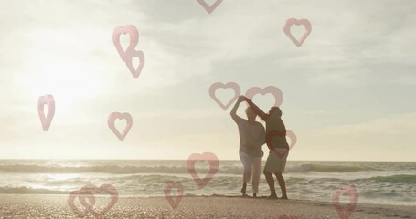 Dancing on beach, couple surrounded by heart shapes animation overlay - Powered by Adobe