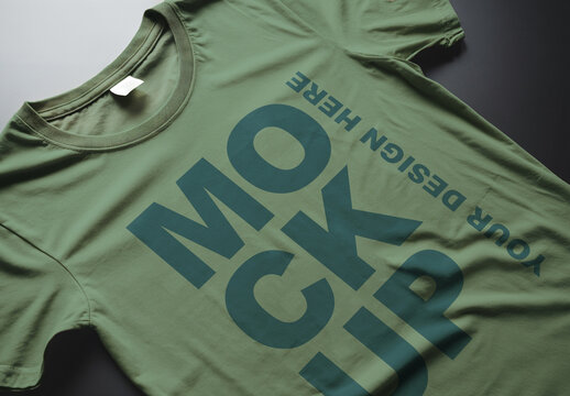 A Closeup of a Green T-shirt Mockup Laying on a Desk
