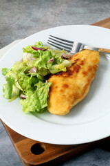 Breaded chicken breast with salad