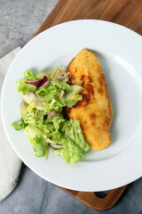 Breaded chicken breast with salad