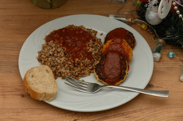 Delicious meal featuring buckwheat and savory patties topped with rich tomato sauce