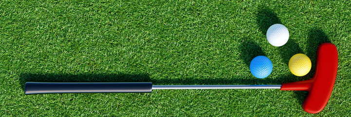 Golf putter and balls on green surface