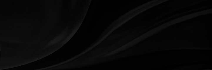 Black gray satin dark fabric texture luxurious shiny that is abstract silk cloth panorama background with patterns soft waves blur beautiful.
