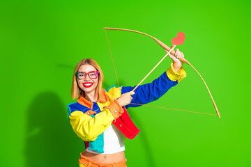 Colorful young woman holding an archery set with a red heart symbol in a vibrant and cheerful...