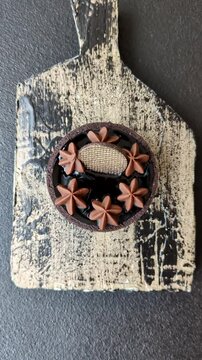 Chocolate tart or dessert with fruit and nuts. Sweet pastries on a dark concrete background