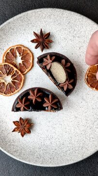 Chocolate tart or dessert with fruit and nuts. Sweet pastries on a dark concrete background