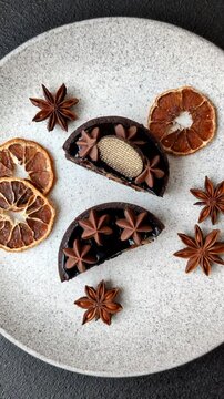 Chocolate tart or dessert with fruit and nuts. Sweet pastries on a dark concrete background