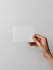 Hand Holding Blank White Card Mockup on Neutral Background Studio Shot