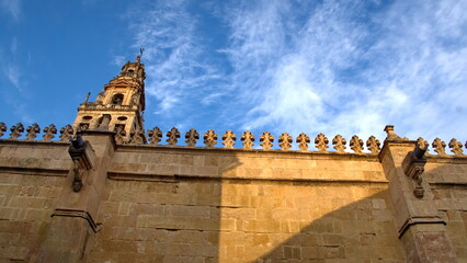 Bell tower built around the minaret of the Mosque-Cathedral of Cordoba, visible above the outer wall, in the historic center of Cordoba, Spain