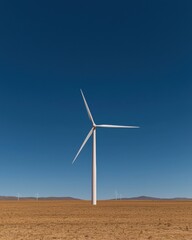 Energy generation from wind turbines in arid landscape with blue sky backdrop, sustainable power concept.