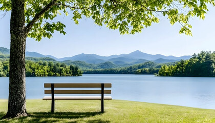 Obraz premium Serene lakeside bench under tree shade, mountain view