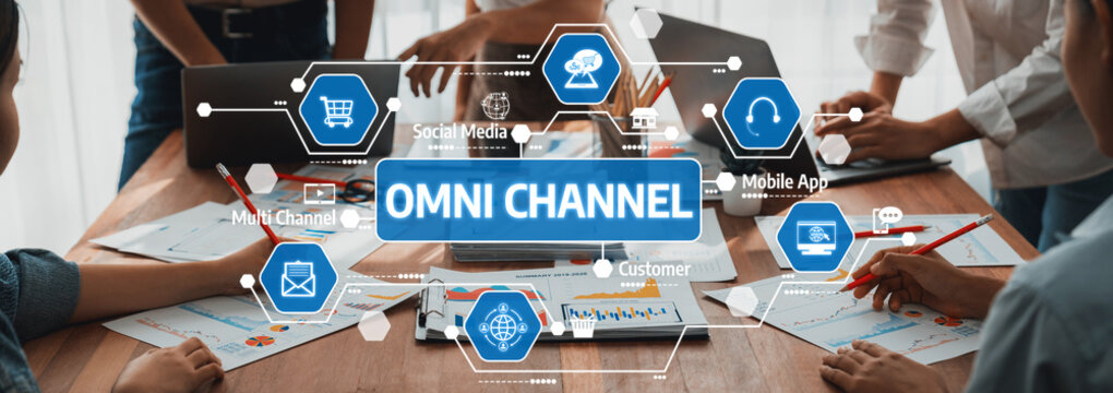 A modern office scene showcasing digital marketing strategies with a focus on omni channel communication. Team members collaborate using technology and visuals for engagement. Amity