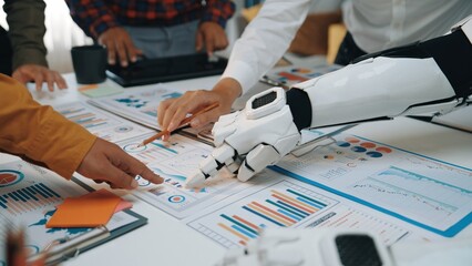 Innovative scene of human and robotic hands collaborating over data reports in a modern workspace,...