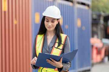 Fototapeta premium Import and export container, Worker inspecting and control of container. Woman worker working and managing container at container yard