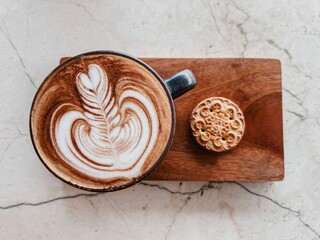Cup of coffee on cutting board