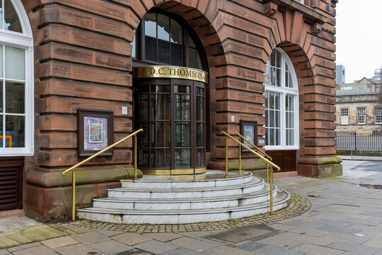 DUNDEE, UK - March 22, 2025: Exterior of DC Thomson Headquarters Entrance in Albert Square With Circular Steps, Brass Handrails, Round Window Doors and Company Branding