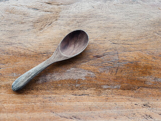 Wooden spoon on wooden surface