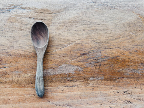Wooden spoon on wooden surface