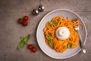 Pasta spaghetti with burrata and tomatoes and fresh basil, top down view. High quality photo