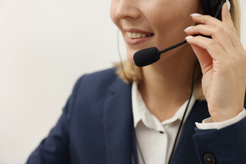 Technical support call center. Smiling operator working indoors, closeup. Space for text
