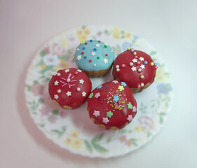sweet Easter bread. homemade muffins, with melted sugar dark red glaze topping, decorated with sprinkles and colored sugar stars