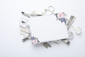 Set of different manicure tools and blank card on white background, flat lay. Space for text