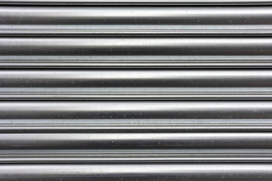 Galvanized Silver Corrugated Metal Security Roller Shutter Door Background Texture with Horizontal Stripe Pattern