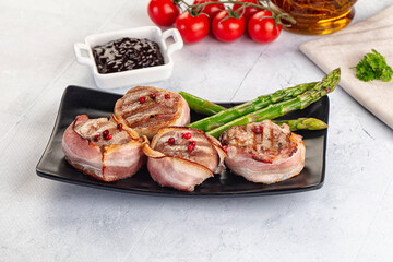 Tasty grilled pork medallion with bacon