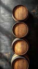 Fototapeta premium Three wine barrels stacked in soft light highlighting warm wood grain