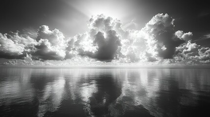 Fototapeta premium Dramatic grayscale seascape, clouds mirroring tranquil ocean.