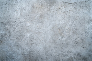 A weathered concrete wall, a testament to time's gentle touch, showing subtle variations in tone and texture across its surface.