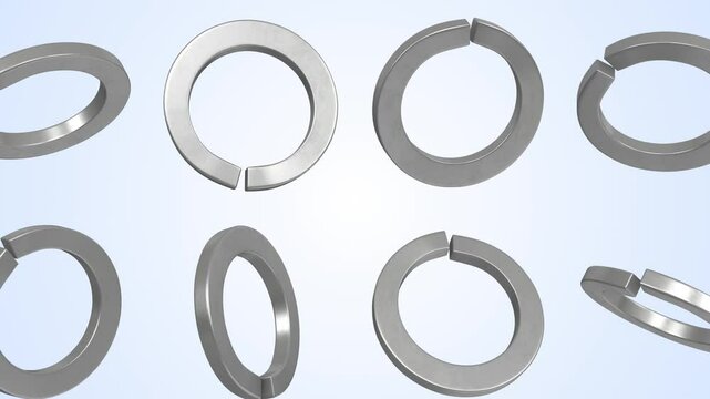 Spring Lock Washers Falling on a Light Blue Background. Split Washers 3D. 4K