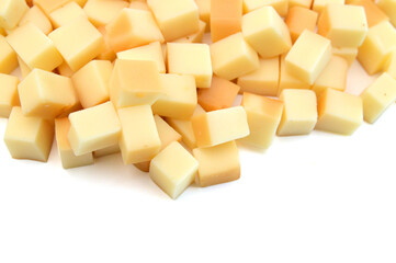 Cubes of cheddar cheese isolated on white 