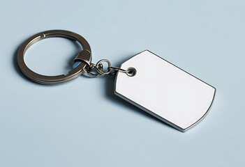 A blank metal keychain tag, ready for personalization, rests on a soft blue background; a minimalist design perfect for customization.