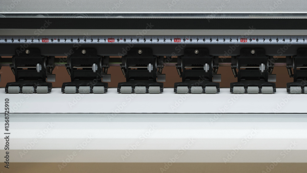 Poster A printer with a ruler on it. The ruler is black and white and has numbers on it
