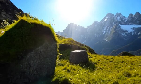 Stones covered with grass and moss under bright sky of Nepal