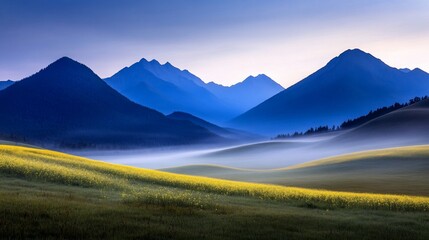 Misty valley with a field of golden flowers and blue mountains beyond