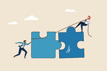 Jigsaw puzzle connection, teamwork partnership to help solve problem or challenge, cooperation or brainstorm to fit and match jigsaw pieces concept, businessman and woman help connect jigsaw puzzle.