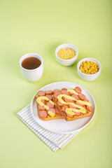 Cheese corn sausages baked sandwich in a plate