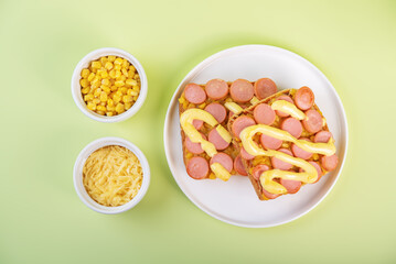 Cheese corn sausages baked sandwich in a plate