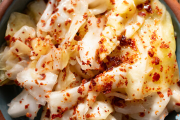 kimchi in fresh white bowl close-up on gray background	