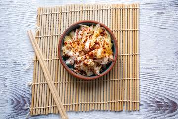 kimchi in fresh white bowl close-up on gray background	