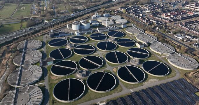 Waste water treatment facility in The Netherlands. Circular basins full of water.