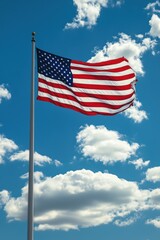 Flag Waving Proudly Against Blue Sky with Clouds on Sunny Day