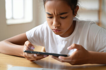Professional photo of a puzzled teenage girl reading a text message on her smartphone.Technology